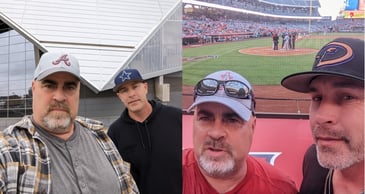 Truck drivers Dan and Tory posing at a football and baseball stadium