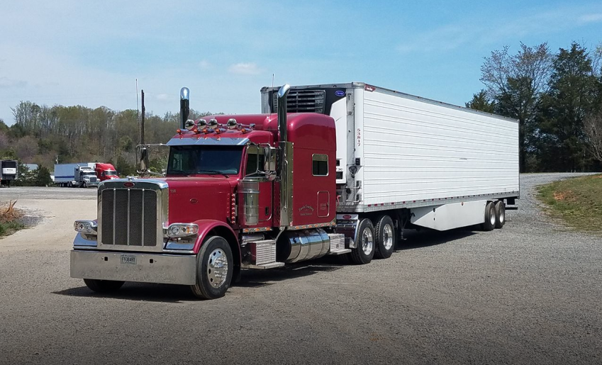 Red truck with long white trailer  