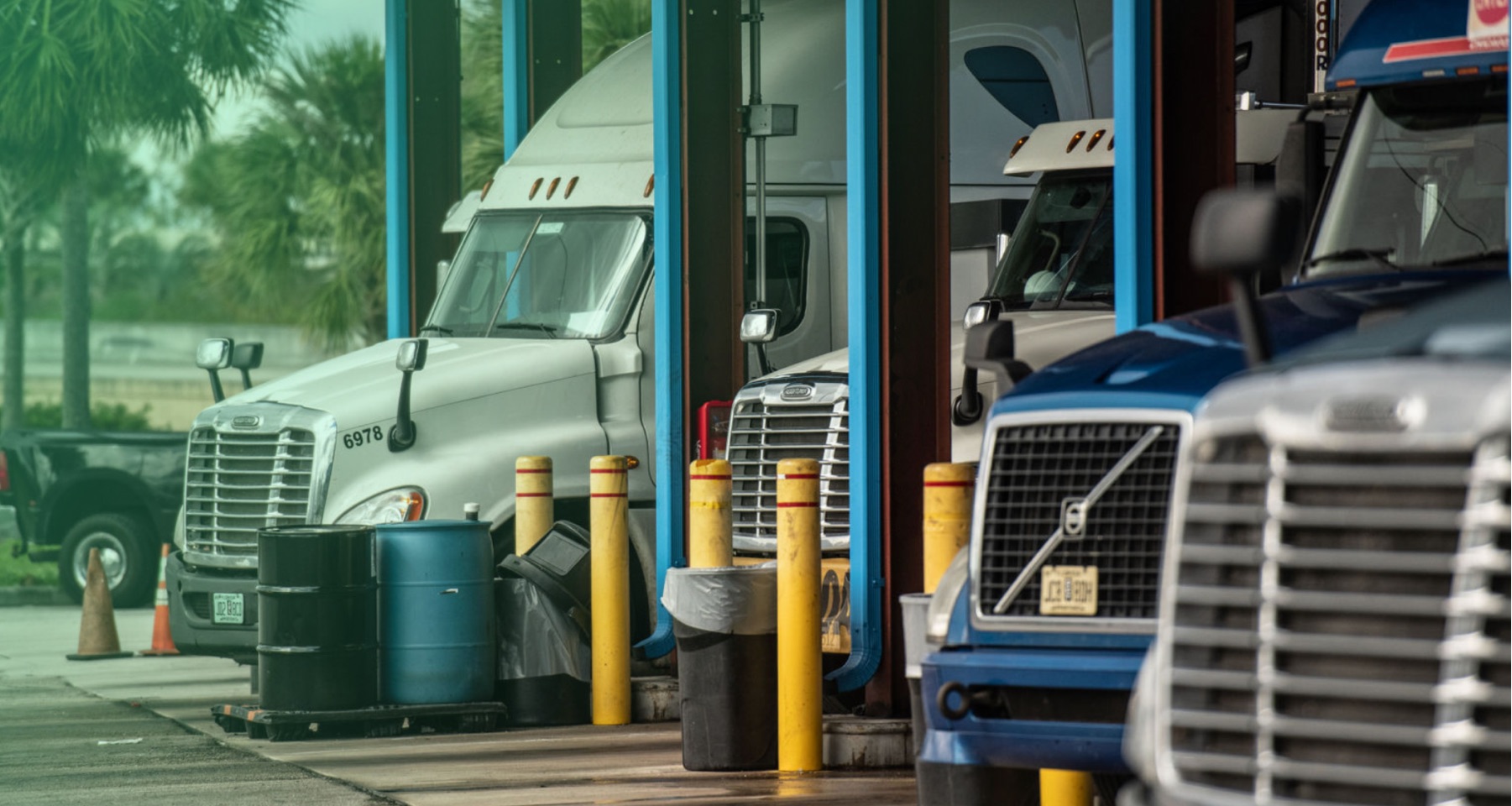 semi trucks parked in a row to refuel with diesel