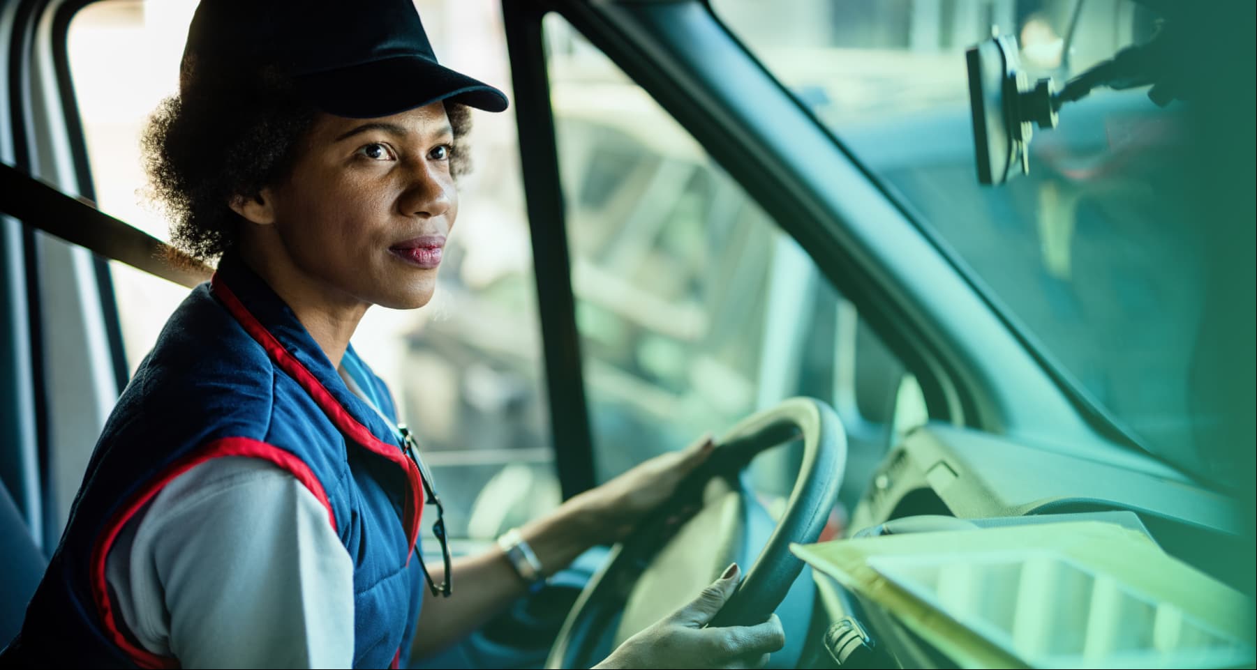 Female driver sitting behind the wheel of a truck 